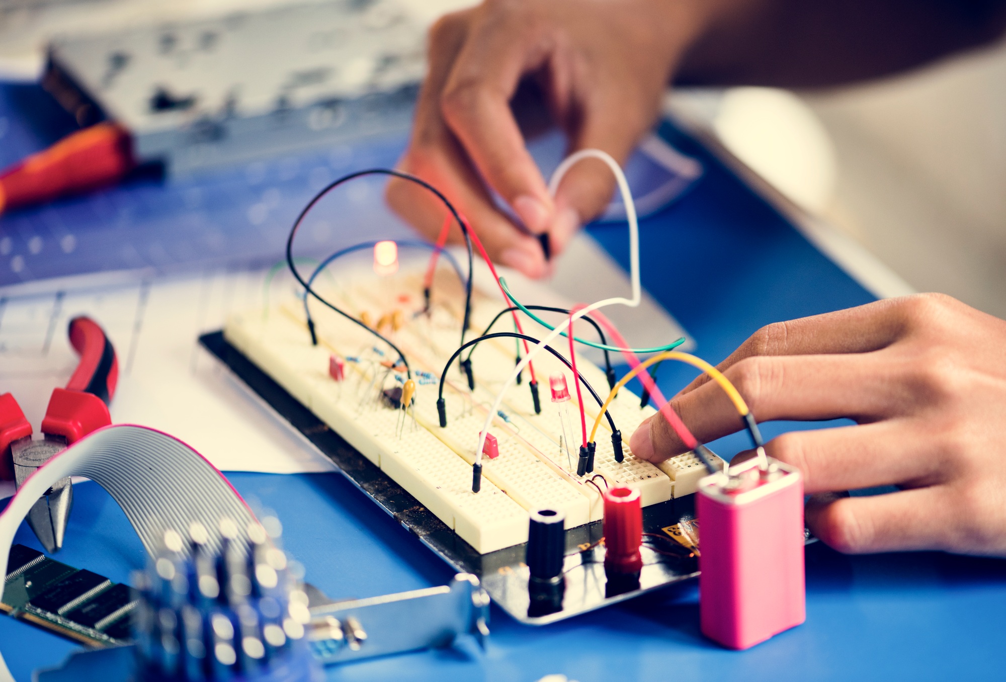 Closeup of hands working on breadboard