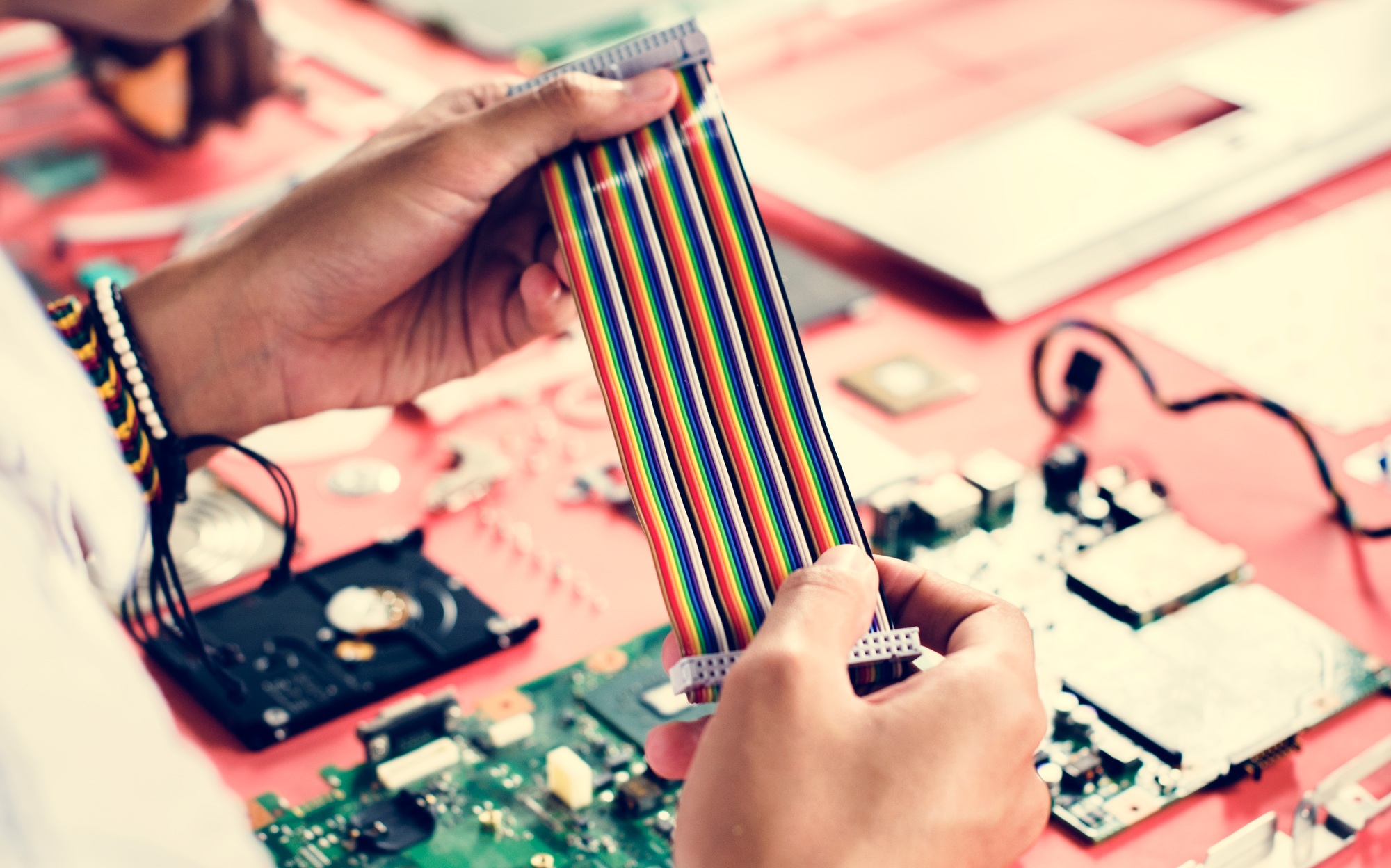 Clsoeup of hands holding computer breadboard flat wires cables