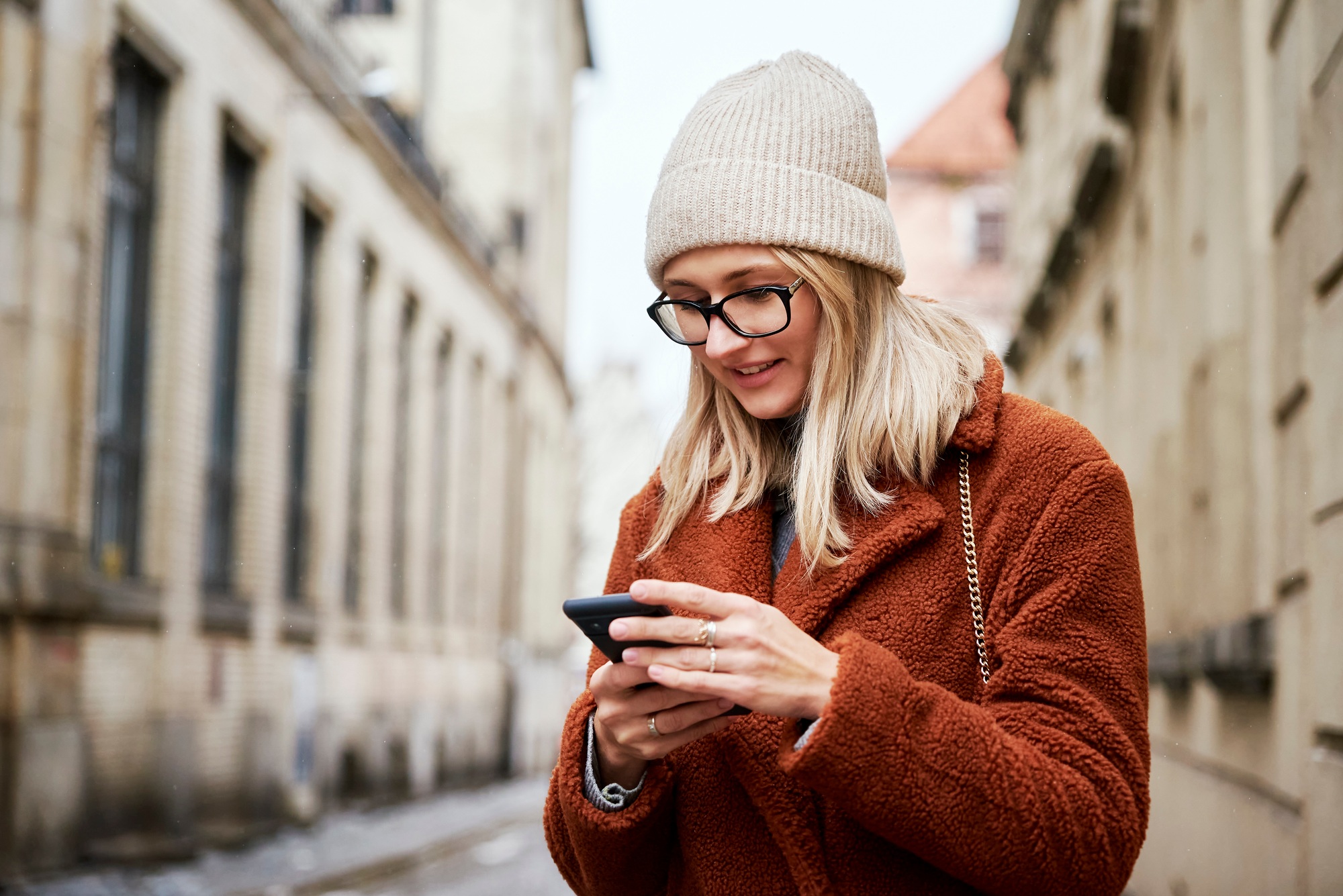 Woman using smartphone at city street